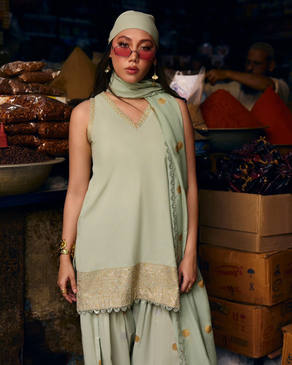 Model in the Honeydew Frost sleeveless sage kurta with lace V-neck and gold embroidered hem