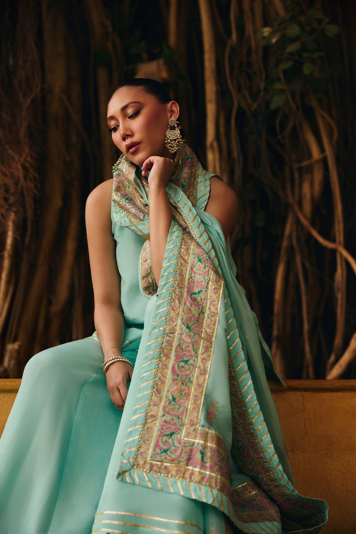 Model seated in Mermaid Majesty, the block-printed silk dupatta with gotta and sequin accents